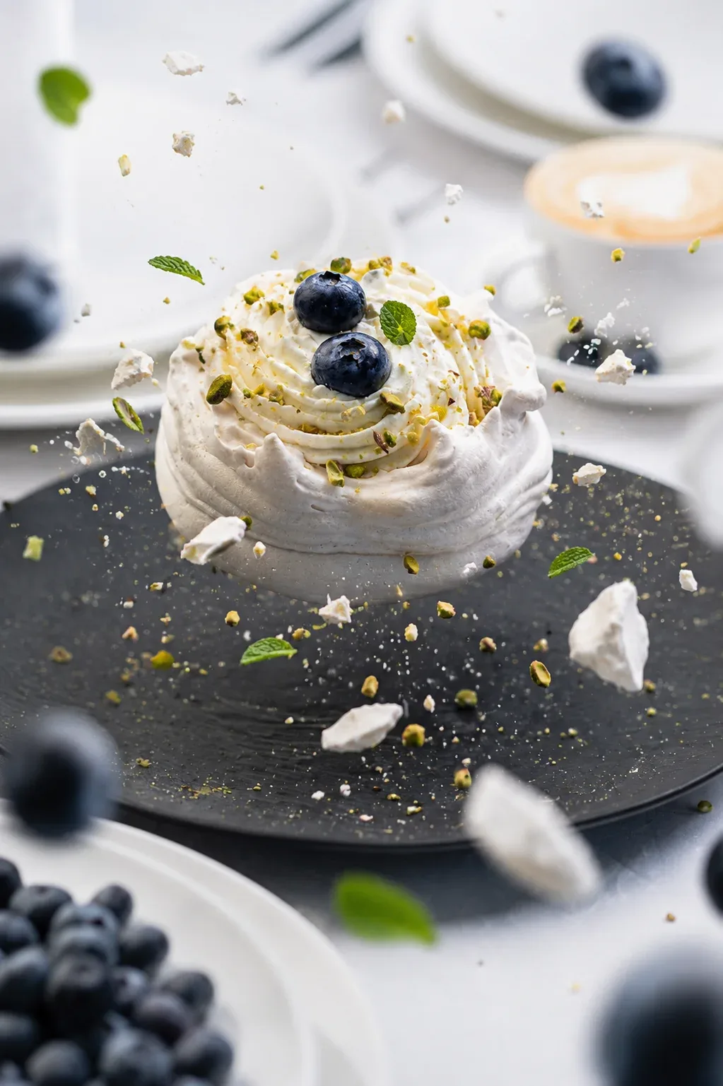 Pavlova meringue dessert with blueberries, pistachio and mint, photo by Alex Slyadnev