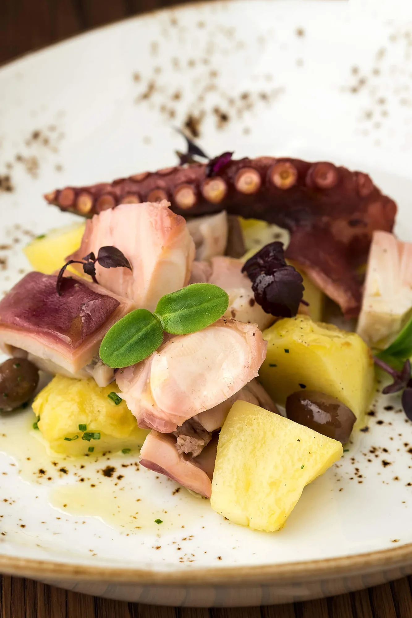 Octopus salad with potatoes, olives and basil, photo by Alex Slyadnev