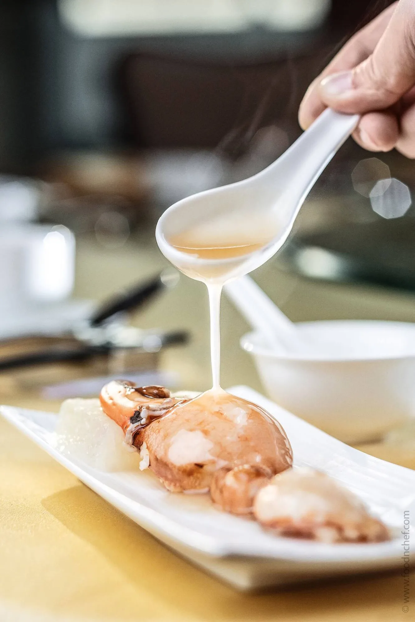 Pouring sauce over lobster in a Chinese restaurant, photo by Alex Slyadnev