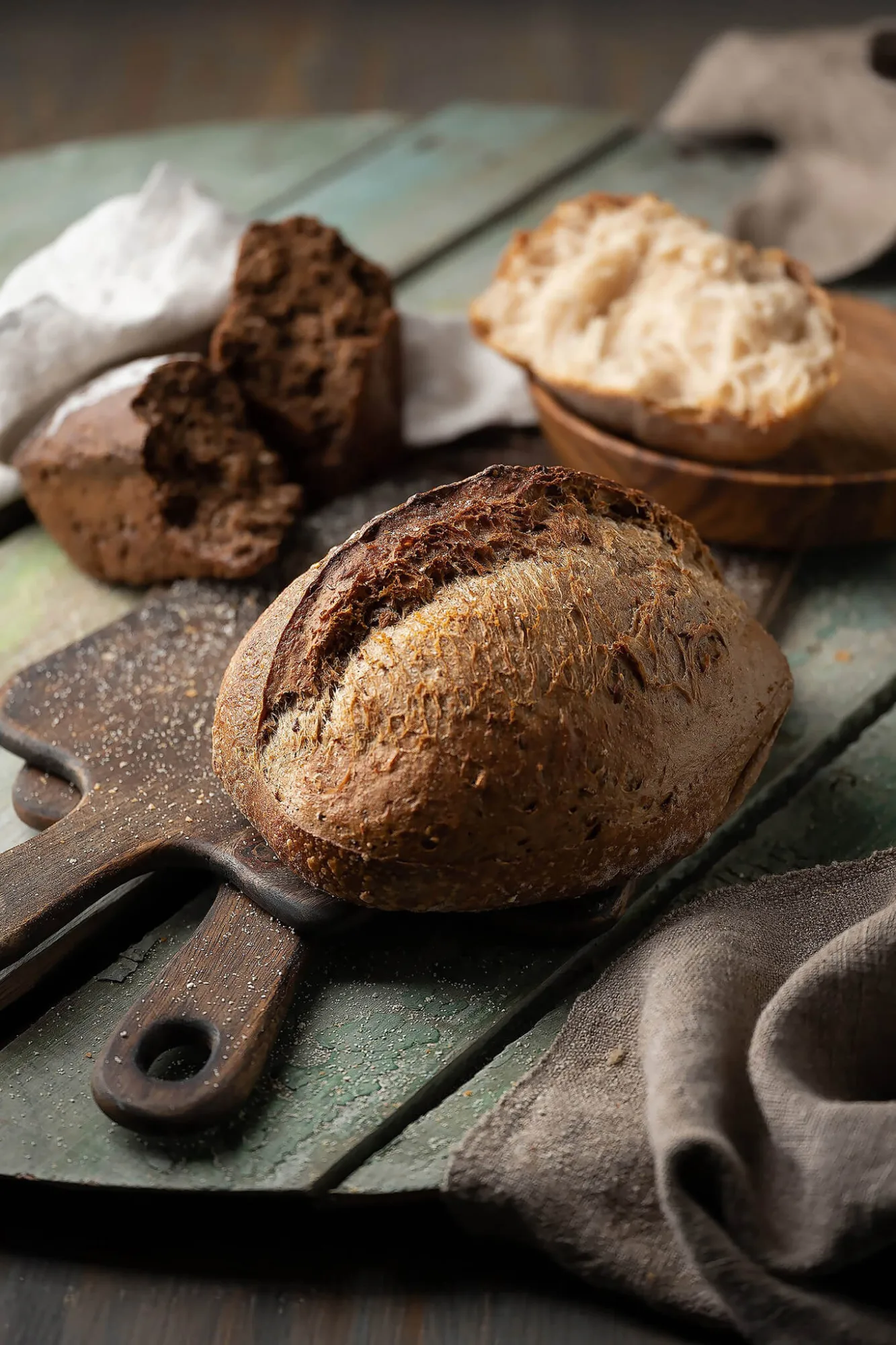 Rustic sourdough bread loaves on wooden boards, photo by Alex Slyadnev